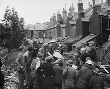 An Injured Child Being Carried from a Bombed Out House, 1940. Creator: British Pathe Ltd