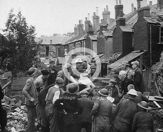 An Injured Child Being Carried from a Bombed Out House, 1940. Creator: British Pathe Ltd.