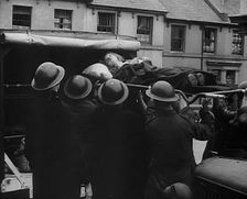 An Injured Child Being Carried Into an Ambulance, 1940. Creator: British Pathe Ltd