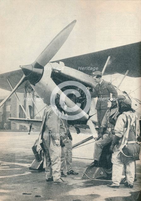 An instructor explaining engine details to a pupils at Sealand Aerodrome, Flintshire, c1936 (c1937). Artist: Unknown.