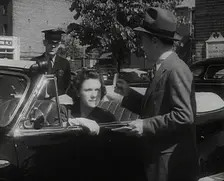An Official Checking a Petrol Ration Card in Washington, District of Columbia, 1942. Creator: British Pathe Ltd