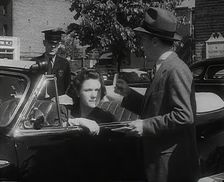 An Official Checking a Petrol Ration Card in Washington, District of Columbia, 1942. Creator: British Pathe Ltd