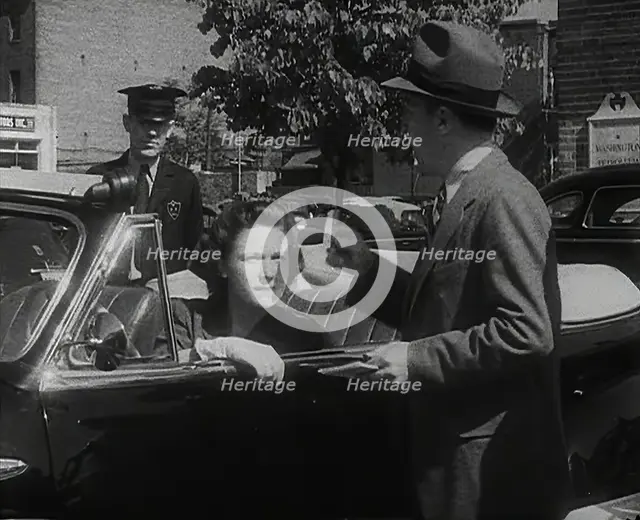An Official Checking a Petrol Ration Card in Washington, District of Columbia, 1942. Creator: British Pathe Ltd.