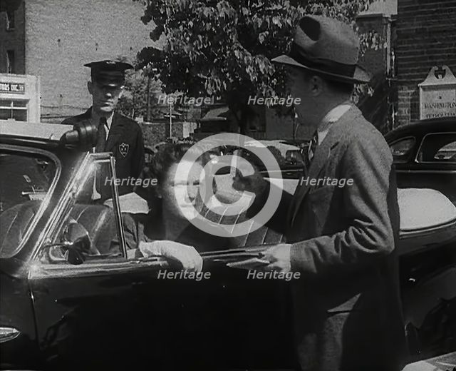 An Official Checking a Petrol Ration Card in Washington, District of Columbia, 1942. Creator: British Pathe Ltd.