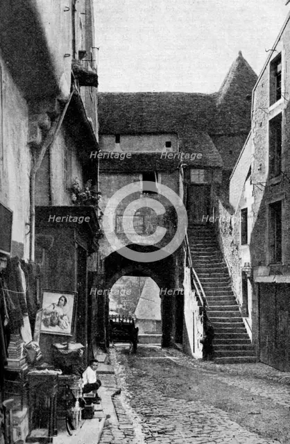 An old curiosity shop in Falaise, Normandy, France, c1930s. Artist: Humphrey Joel