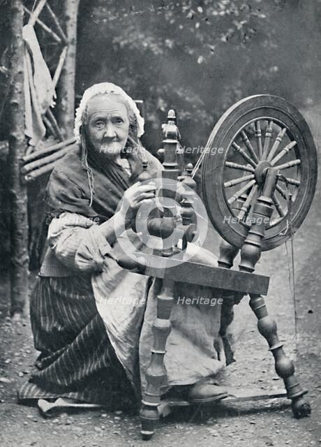 An old Irish woman at her spinning-wheel, 1912. Artist: W Lawrence.