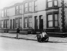 An Orderly Boy and his cart sweeping a street, Liverpool, 1935
