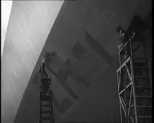 An R 38 Airship Body Being Painted in a Hangar, 1921. Creator: British Pathe Ltd