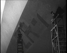 An R 38 Airship Body Being Painted in a Hangar, 1921. Creator: British Pathe Ltd
