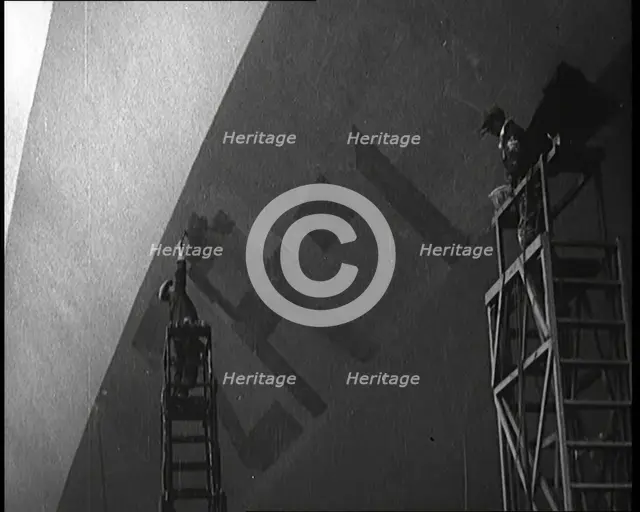 An R 38 Airship Body Being Painted in a Hangar, 1921. Creator: British Pathe Ltd.