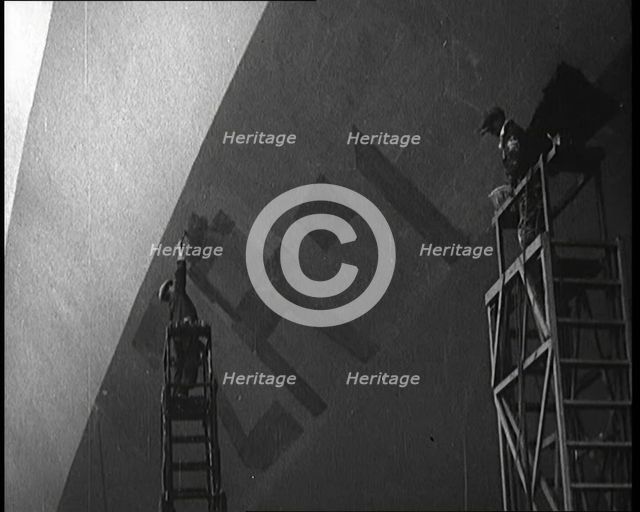 An R 38 Airship Body Being Painted in a Hangar, 1921. Creator: British Pathe Ltd.