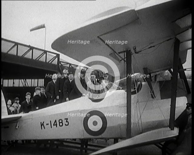 An RAF Officer Showing a Group of Male Children His Aeroplane, 1931. Creator: British Pathe Ltd.