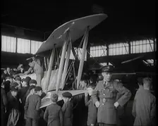 An RAF Officer Showing a Group of Male Children His Aeroplane, 1931. Creator: British Pathe Ltd