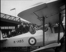 An RAF Officer Showing a Group of Male Children His Aeroplane, 1931. Creator: British Pathe Ltd