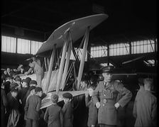 An RAF Officer Showing a Group of Male Children His Aeroplane, 1931. Creator: British Pathe Ltd