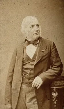 An unidentified man leaning on a cabinet, c1880s. Creator: Frederick Mulnier