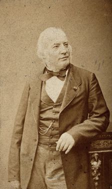 An unidentified man leaning on a cabinet, c1880s. Creator: Frederick Mulnier
