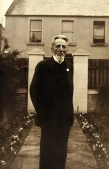 An unidentified man, standing in a garden, c1900. Creator: Unknown