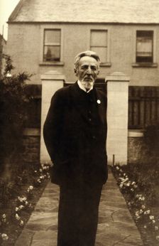 An unidentified man, standing in a garden, c1900. Creator: Unknown