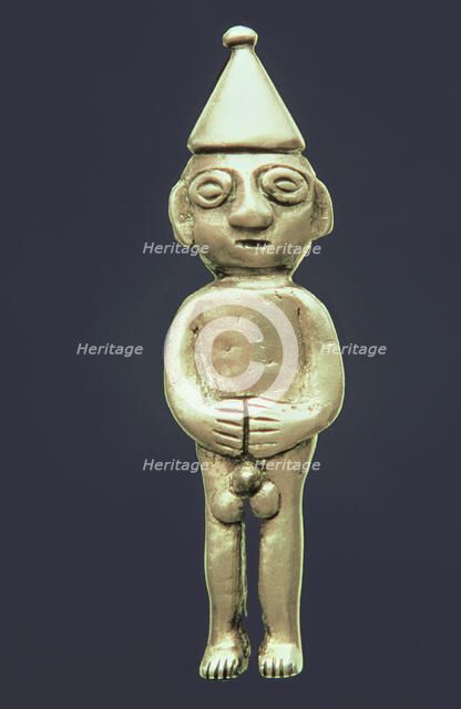 Anthropomorphic figure made of silver representing a male person standing with his hands on the b…