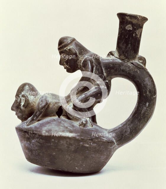 Anthropomorphic Vase with stirrup handle depicting two male persons performing a sex act, belongi…