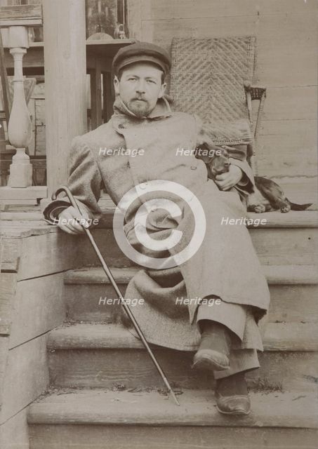 Anton Chekhov (1860-1904) with dog Hina. Melikhovo, 1897.