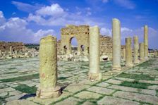 Antonine Gate and ruined pillars, Sbeitla, Tunisia. Creator: Vivienne Sharp