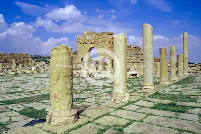 Antonine Gate and ruined pillars, Sbeitla, Tunisia.  Creator: Vivienne Sharp.