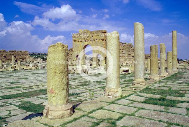Antonine Gate and ruined pillars, Sbeitla, Tunisia.  Creator: Vivienne Sharp.