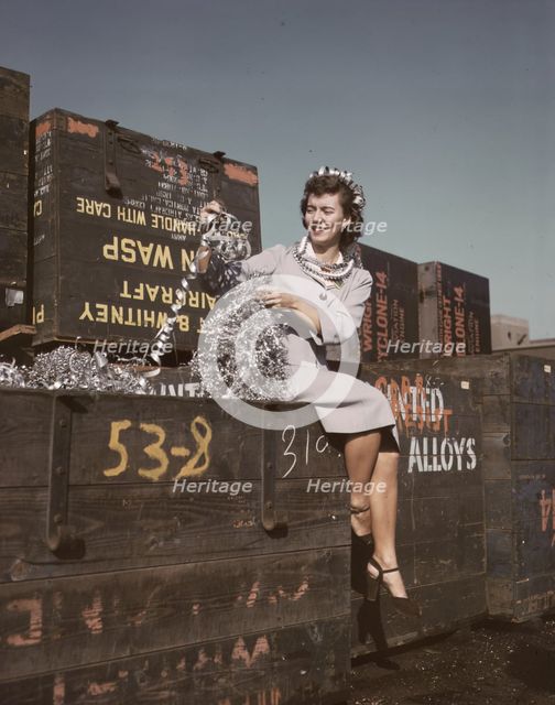 Annette del Sur publicizing salvage campaign...Douglas Aircraft Company, Long Beach, Calif., 1942. Creator: Alfred T Palmer.