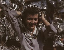 Annette del Sur publicizing salvage campaign...Douglas Aircraft Company, Long Beach, Calif., 1942. Creator: Alfred T Palmer