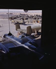 Another North American B-25 bomber rolls off the final assembly line to join other ships..., 1942. Creator: Alfred T Palmer