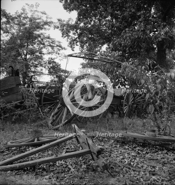 Abandoned coaches and wagons...old blacksmith shop, Wray Plantation, Greene County, Georgia, 1937. Creator: Dorothea Lange.
