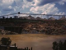Above the construction work, the aggregate storage pile which..., Fort Loudoun Dam, Tenn., 1942. Creator: Alfred T Palmer