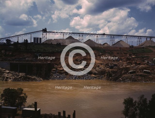 Above the construction work, the aggregate storage pile which..., Fort Loudoun Dam, Tenn., 1942. Creator: Alfred T Palmer.