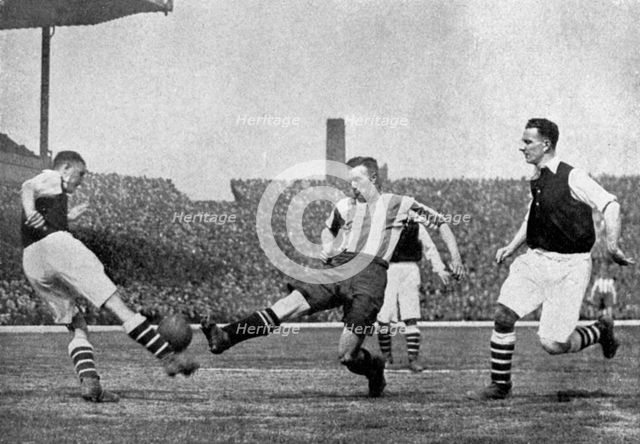 Action from an Arsenal v Sheffield United football match, c1927-1937.Artist: London News Agency
