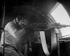 Actor Clark Gable Firing a Machine Gun Out of a Warplane, 1943-1944. Creator: British Pathe Ltd