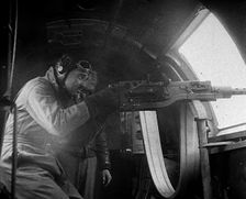 Actor Clark Gable Firing a Machine Gun Out of a Warplane, 1943-1944. Creator: British Pathe Ltd