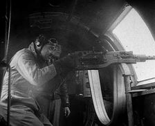 Actor Clark Gable Firing a Machine Gun Out of a Warplane, 1943-1944. Creator: British Pathe Ltd