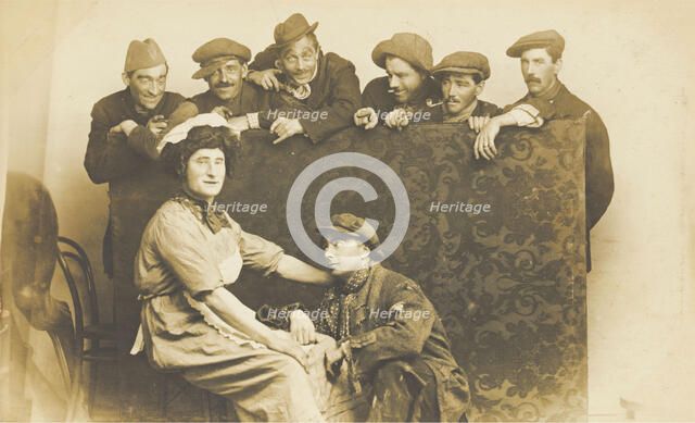 Actors gathered around a man in drag, between 1910 and 1919. Creator: Unknown.