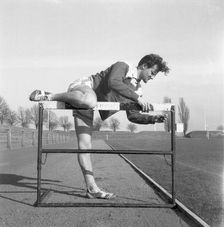 Adjusting a hurdle on an athletics track, Landskrona, Sweden, 1955