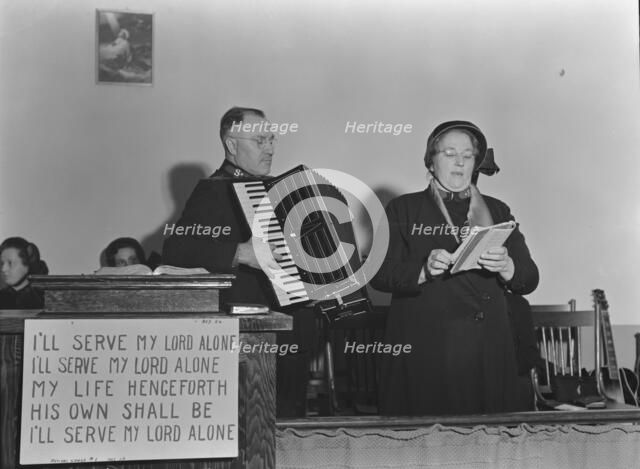 Adjutant and his wife sing, Salvation Army, San Francisco, California, 1939. Creator: Dorothea Lange.