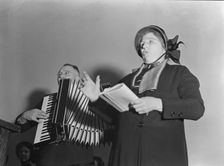 Adjutant and his wife sing, Salvation Army, San Francisco, California, 1939. Creator: Dorothea Lange