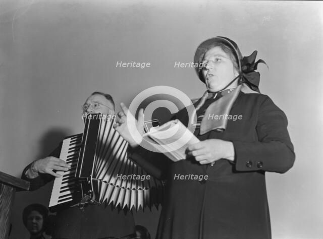 Adjutant and his wife sing, Salvation Army, San Francisco, California, 1939. Creator: Dorothea Lange.