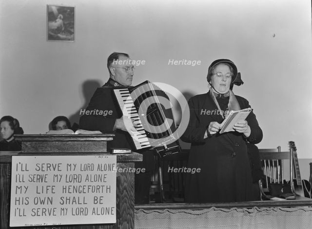 Adjutant and his wife sing, Salvation Army, San Francisco, California, 1939. Creator: Dorothea Lange.