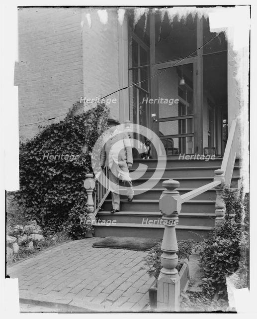Admiral George Dewey on steps of house, Washington D.C., between 1890 and 1910. Creator: Levin Handy.
