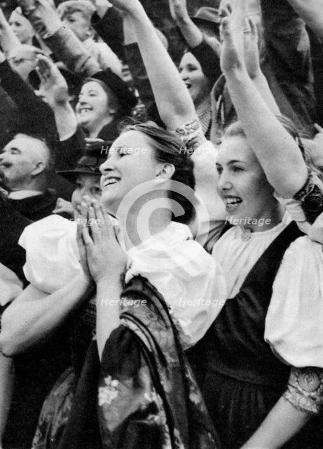 Admiring crowd saluting German Nazi leader Adolf Hitler, 1938. Artist: Unknown