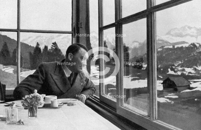 Adolf Hitler admiring the view out a window near Garmisch, Bavaria, Germany, 1936. Artist: Unknown