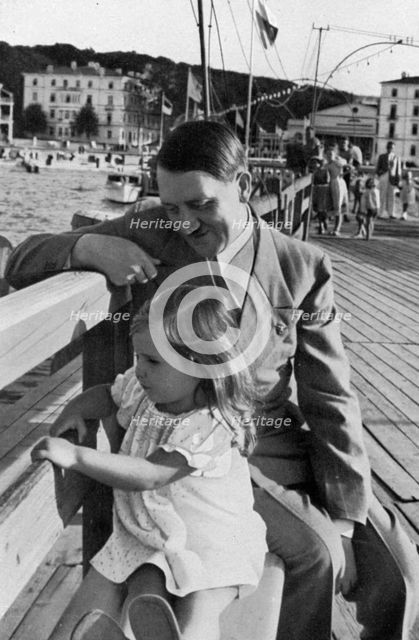 Adolf Hitler and Helga Goebbels, 1936. Artist: Unknown