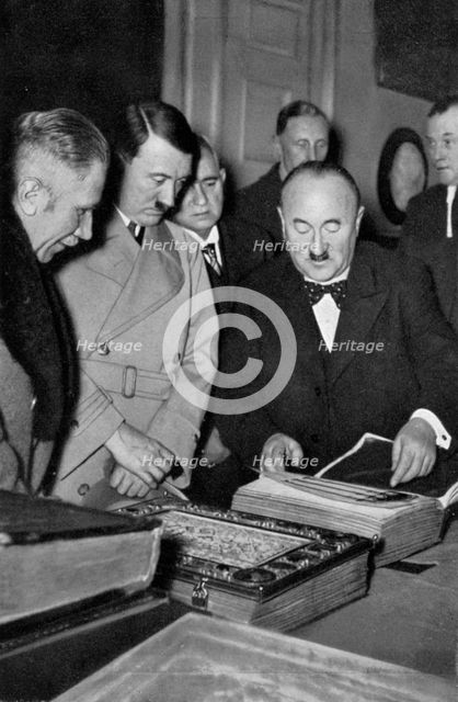Adolf Hitler being shown the treasures of the Bavarian State Library, Germany, 1936. Artist: Unknown